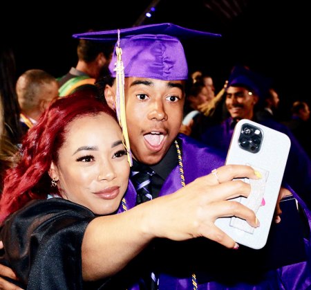 Teacher Brandi Hurd takes a selfie with a grad.